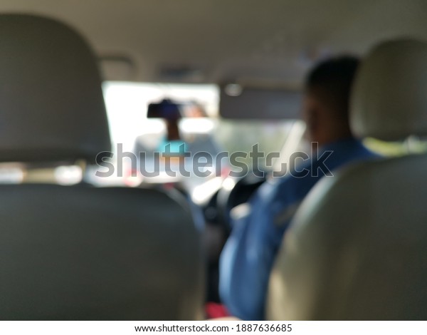 Blur focus of\
driver in the car.Blur focus of View of the road in the city\
through the windshield of the\
car