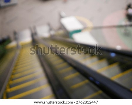 Blur focus of escalator elevator stairs lift in shoping mall.