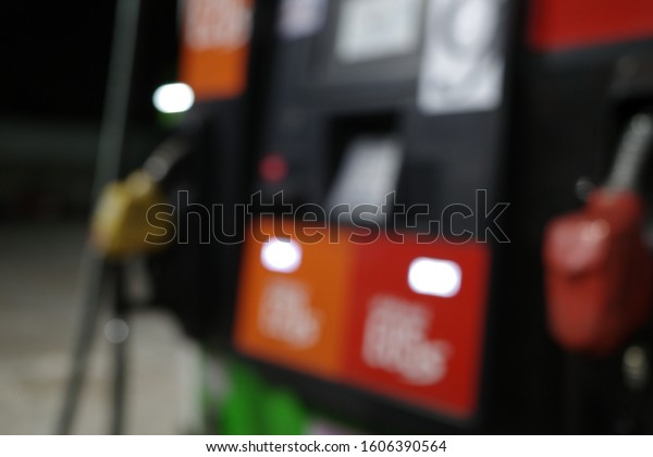 Blur focus of gas gun with car.Blur focus of\
Pump nozzles in a service station, Gas.Blur focus of Multi color\
fuel pistols on fuel\
station.