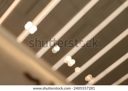 Blur focus of The hanging rounded ceiling mounted light fixtures with modern LED light bulb,Architecture and interior design round lights on ceiling.