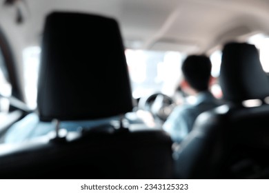 Blur focus of Inside view of car  on the back of car seat. with blurred traffic jam on the road.