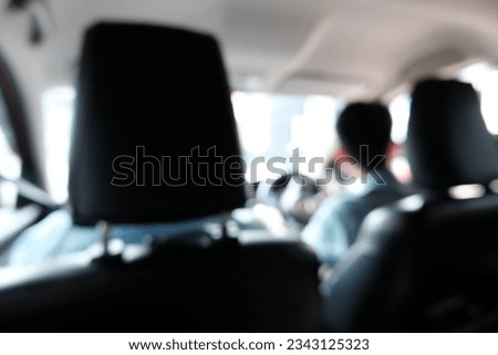 Blur focus of Inside view of car  on the back of car seat. with blurred traffic jam on the road.