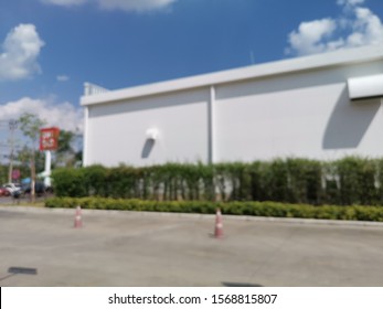 Blur Focus Of Modern Distribution Center From Outside,Warehouse With Blue Sky