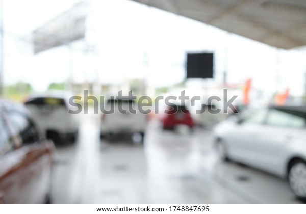 Blur focus of new\
cars in showroom blurred defocused background.Blur focus of New\
cars at dealer showroom.