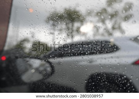 Blur focus of raindrop on windshield, car drive in rainy day weather