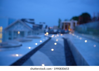 Blur Focus Of Sky Lounge Infinity Pool On Rooftop With Beautiful Seascape Night View.