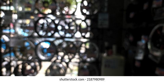 Blur Focus Of View Of Variety Of Brand New, Colours, And Designed Alloy Rims And Wheels On Display Shelf For Sale In A Garage Wheel Shop