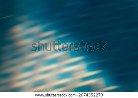 Blur glow background. Light flare. Underwater radiance reflection. Bokeh beam. Defocused blue orange rays flecks texture dark abstract overlay.