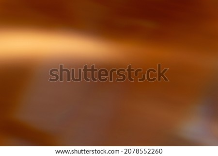 Blur glow overlay. Color gradient. Optical radiance filter. Lens flare. Defocused holographic golden bronze light on dark smooth texture abstract background.