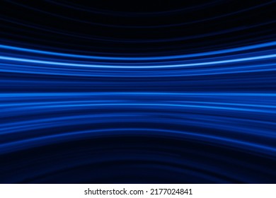 Blur glowing lines. Neon abstract background. Futuristic radiance. Defocused luminous navy blue color curve streak light flare motion on dark black. - Shutterstock ID 2177024841