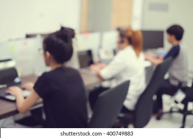 Blur Group Of Asian Staff Working In Operation Office Room For Customer Support Service Concept.