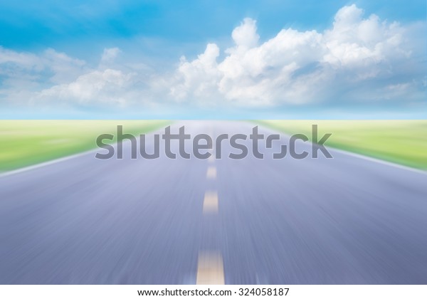 blur high\
speed road with blue skies\
background