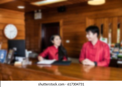 Blur Of Hotel Lobby Front Desk With Unrecognizable People.