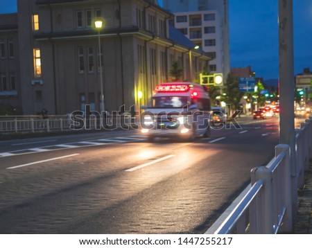 Blur image of ambulance or emergency  car on the road at  evening