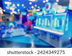 Blur image of arcade machine game for children game play in modern shopping mall,colorful neon lights.