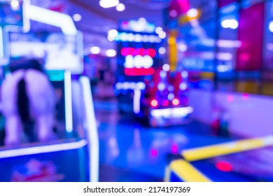 Blur Image Of Arcade Machine Game For Children Game Play In Modern Shopping Mall,colorful Neon Lights.