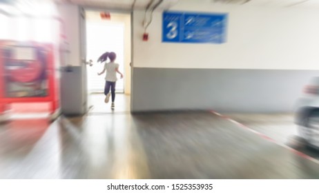 Blur Image Of Asian Girl Run To The Fire Exit Door In The Mall.