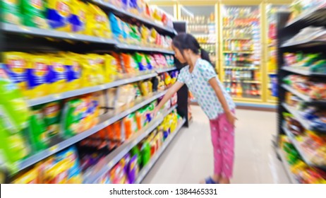 Blur Image Of Asian Kid Choose To Buy Snacks In Convenience Stores.Many Snacks In Convenience Stores Are Not Helpful For Children.