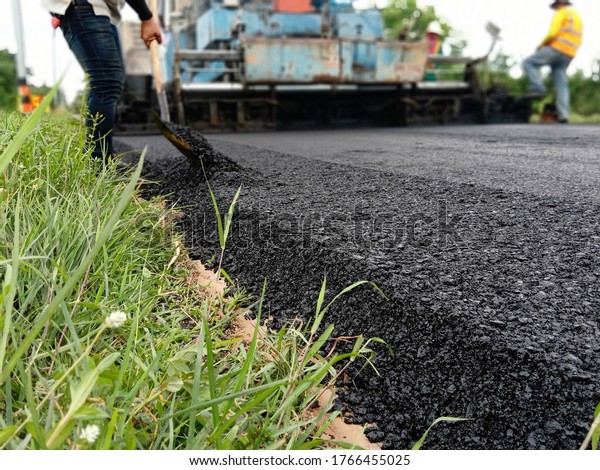 Blur image, asphalt paving With heavy\
machinery in Thailand\
\
