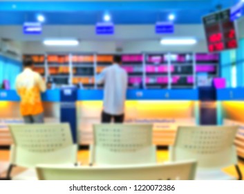 Blur Image Back Side Of 2 Men Are Contacting Financial Transactions In Front Of Bar Counter Of Bank With Digital Queuing Techniques Program And Empty Chair On Convenience Service In Business Concept 