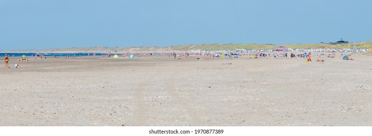 Blur image of beach scenery with many tourist for background usage
