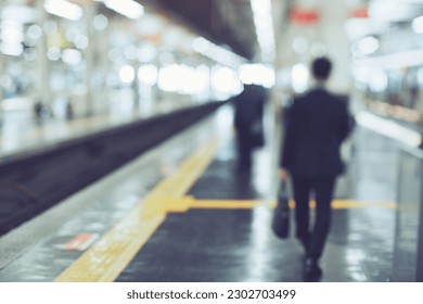 Blur image of businessman walking on platform
