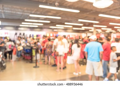 Blur Image Cashier With Long Line Of People Waiting At Checkout Counter In Fitness Store At Outlet Shopping Mall In Houston, Texas, US. Cashier Register And Checkout Payment Concept Background.