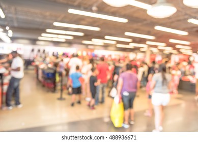 Blur Image Cashier With Long Line Of People Waiting At Checkout Counter In Fitness Store At Outlet Shopping Mall In Houston, Texas, US. Cashier Register And Checkout Payment Concept Background.