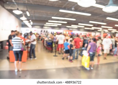 Blur Image Cashier With Long Line Of People Waiting At Checkout Counter In Fitness Store At Outlet Shopping Mall In Houston, Texas, US. Cashier Register And Checkout Payment Concept Background.