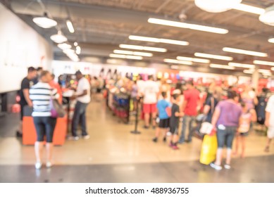 Blur Image Cashier With Long Line Of People Waiting At Checkout Counter In Fitness Store At Outlet Shopping Mall In Houston, Texas, US. Cashier Register And Checkout Payment Concept Background.