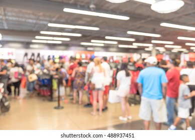 Blur Image Cashier With Long Line Of People Waiting At Checkout Counter In Fitness Store At Outlet Shopping Mall In Houston, Texas, US. Cashier Register And Checkout Payment Concept Background.