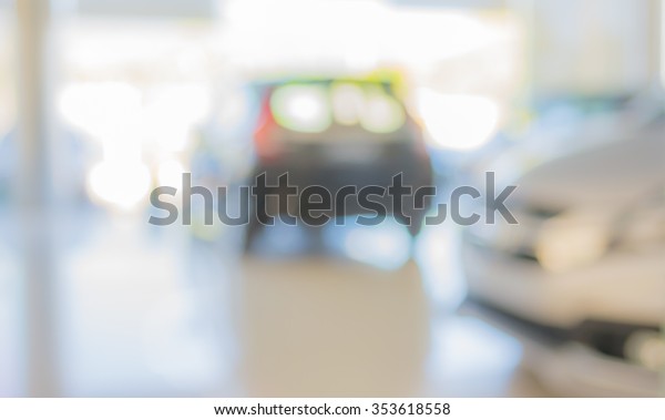 blur image of Commercially cars stand\
in show room of car shop for background usage\
.
