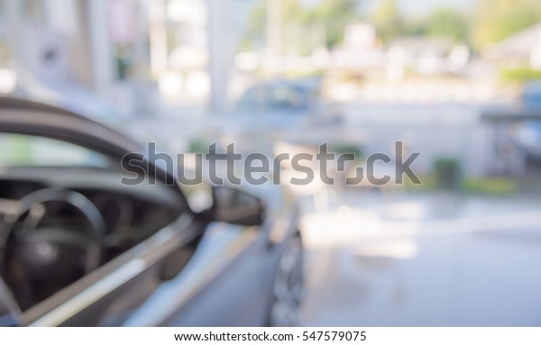 blur image of Commercially cars stand\
in show room of car shop for background usage\
.
