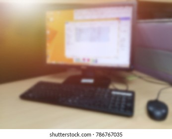 blur image of desktop computer on office desk