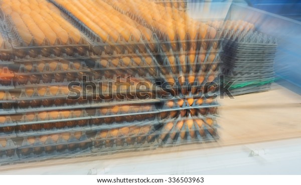 blur image\
of egg pallets in the truck on day\
time.