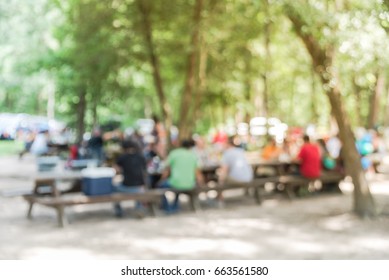 Blur Image Group Of People Hanging Out At Semi Forest, Wooded Area Of Craft Brewery In Conroe, Texas, US. Beer Garden Fill With Picnic Tables, Long Benches Setup Under Tall Oak Trees. Park Activities.