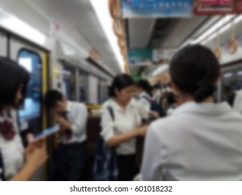 Blur Image Of Inside A Crowded Train With Student And Working People During Rush Hour.