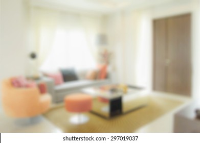 blur image of modern living room interior with orange tone decoration