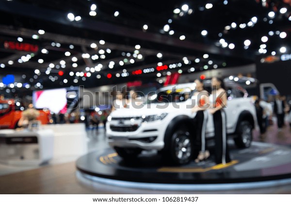 Blur image of\
new car in motor show\
exhibition