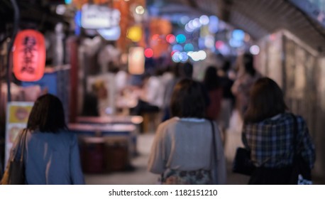 Blur image of pedestrian walking under the railway track bridge tunnel  in  Yurakucho district at night. - Powered by Shutterstock