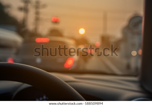 blur image of people driving car on\
day time for background usage.(take photo from\
inside)