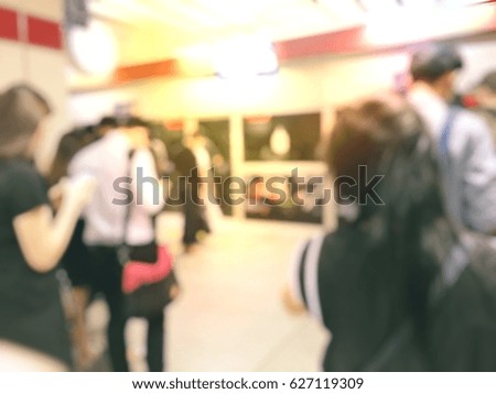 Blur image of people waiting for their respective public transport.