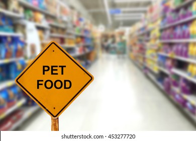 Blur Image Of Pet Food Aisle In Supermarket With Message