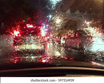 Blur Image Of Rain Drop On Car Glass While The Trafic Jam.

