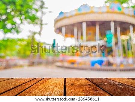 blur image of roundabout in theme park for background usage.