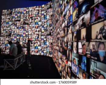 Blur large LED screen show many people's faces join big online event or virtual reality live conference. Big video call seminar, Work from home, Social distancing, New normal event production. - Shutterstock ID 1760059589