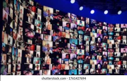 Blur Large LED Screen Show Many People's Faces Join Big Online Event Or Virtual Reality Live Conference. Big Video Call Seminar, Work From Home, Social Distancing, New Normal Event Production.  