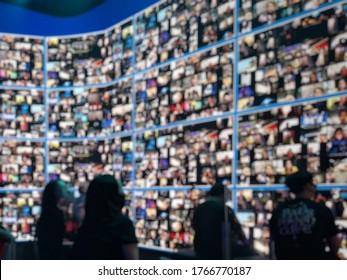 Blur Large LED Screen Show Many People's Faces Join Big Online Event Or Virtual Reality Live Conference. Big Video Call Seminar, Work From Home, Social Distancing, New Normal Event Production.  