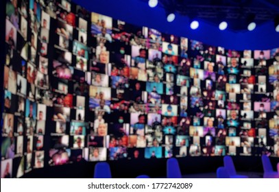 Blur Large LED Screen Show Many People's Faces Join Big Online Event Or Virtual Reality Live Conference. Big Video Call Seminar, Work From Home, Social Distancing, New Normal Event Production.