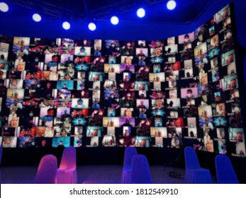 Blur Large LED Screen Show Many People's Faces Join Big Online Event Or Virtual Reality Live Conference. Big Video Call Seminar, Work From Home, Social Distancing, New Normal Event Production.  